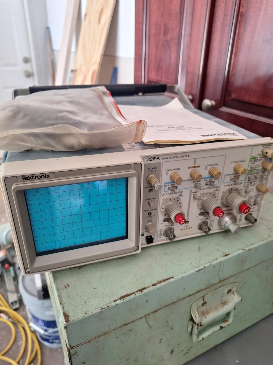 Tektronix 2215A oscilloscope, powered on with a live trace