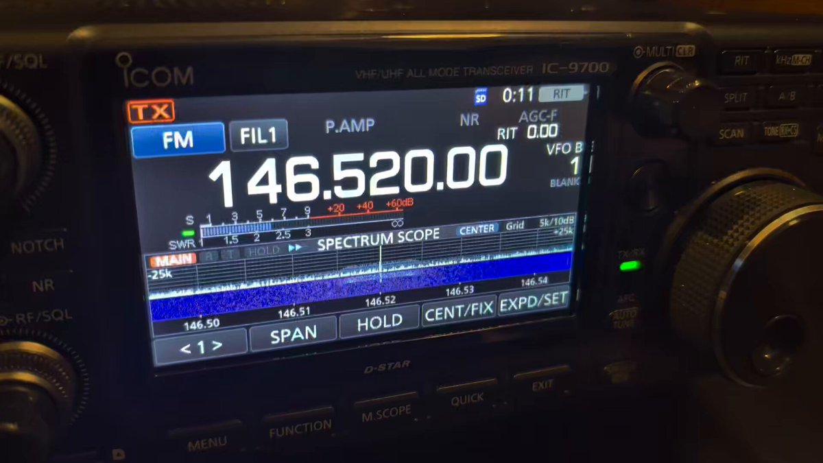 An ICOM IC-9700 display showing FM mode on 146.520.00 MHz, transmitting, with the spectrum scope active
