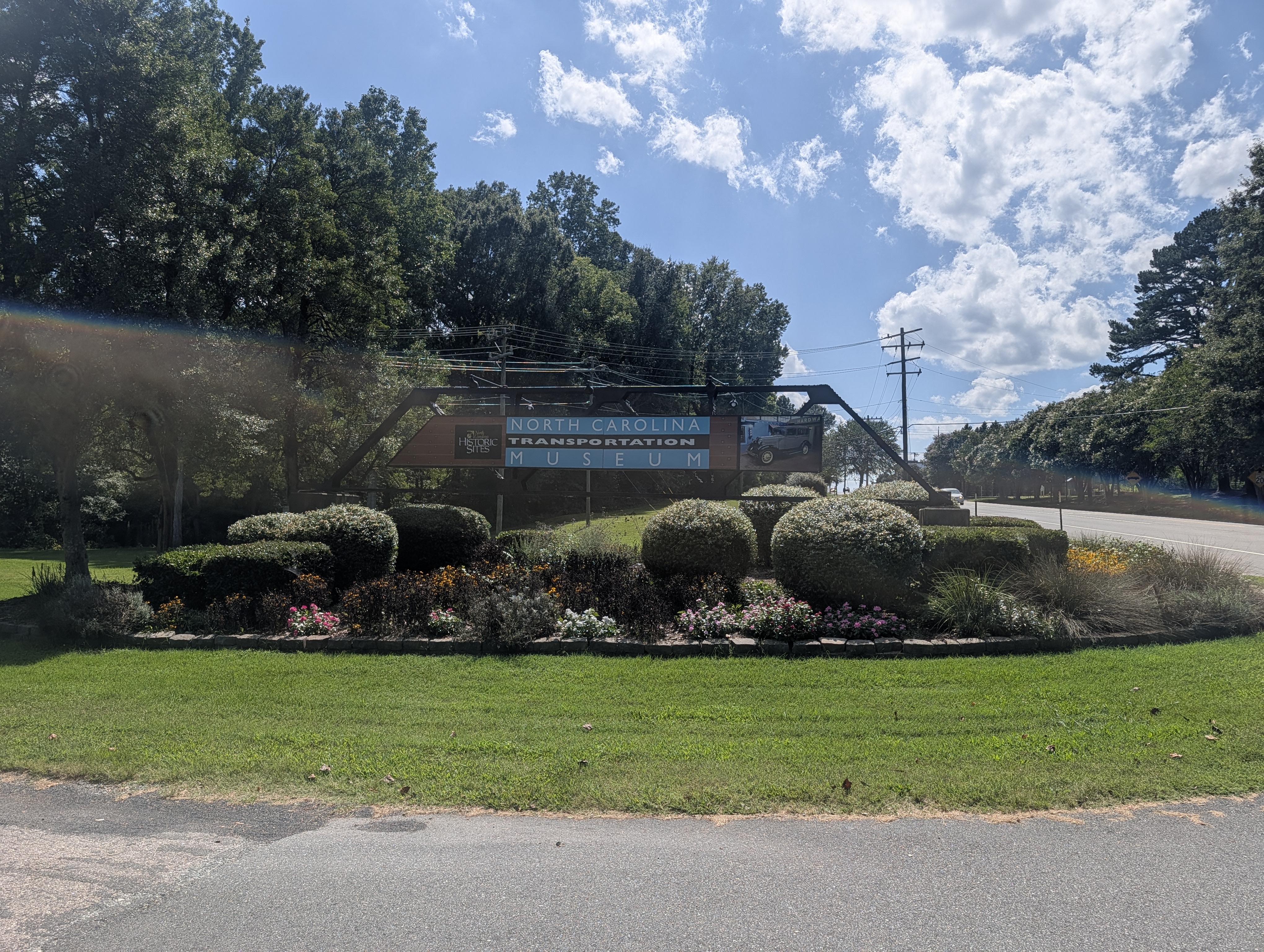 Entrance sign for the North Carolina Transportation Museum, with landscaped gardens in front