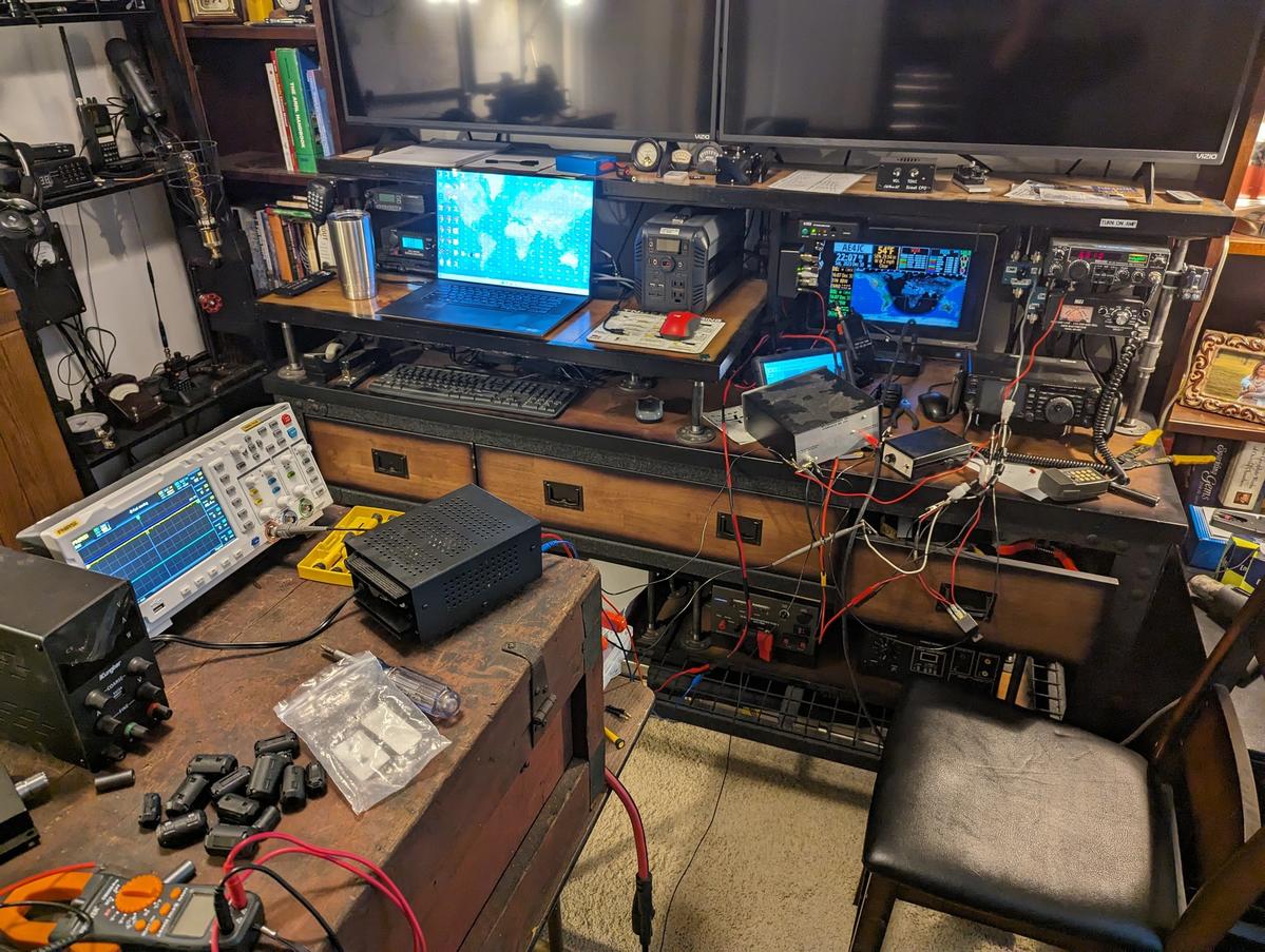 The shack mid-troubleshoot — oscilloscope out, chasing the IC-255A/TE-32 AC hum
